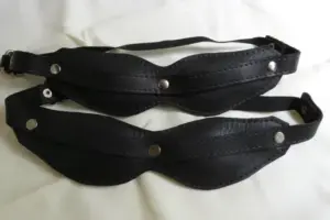 Black leather blindfolds used in advanced femdom sensory deprivation play