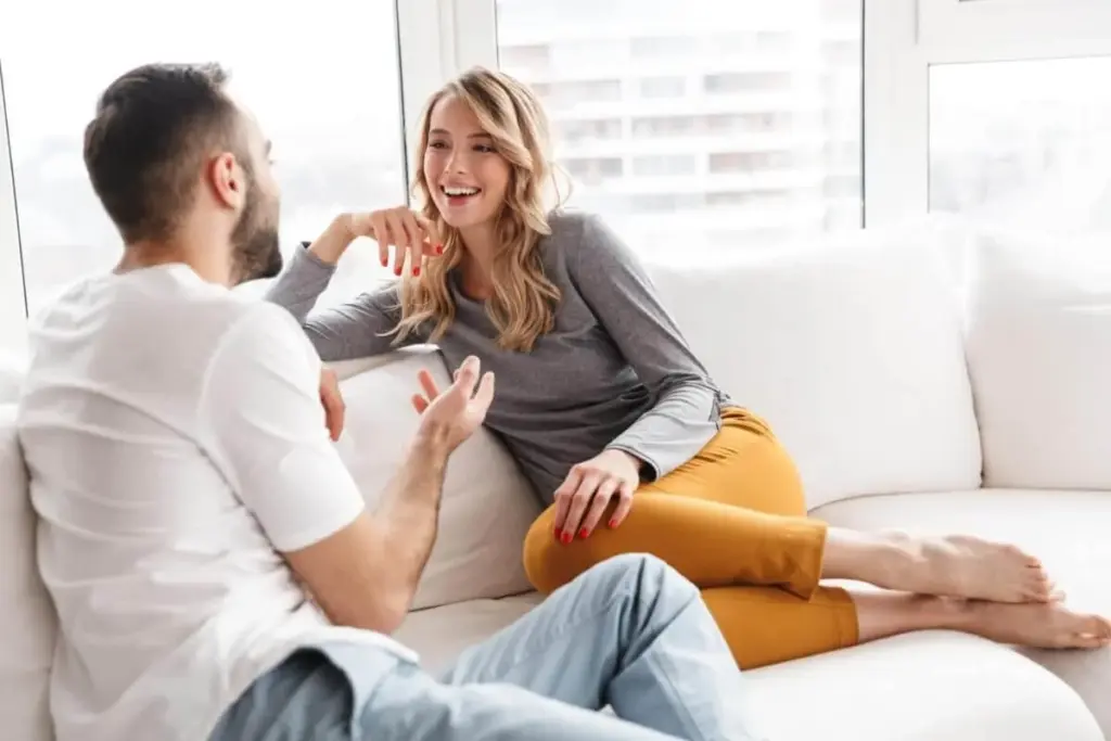 Couple engaged in a serious conversation, setting boundaries and discussing consent in a consensual non-monogamous relationship.