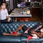 Cuckold Relationships dynamic, with a man observing his partner with another man, symbolizing power exchange and emotional complexity.